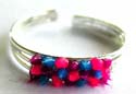 Triple bang sterling silver toering with multi color spiky-out beads at center