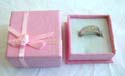 Pinkish sqaure ring display box with flower knot top decor 