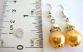 Fashion fish hook earring with one white and one yellow color imitation pearl beads holding a cz ring central decor, gloden bead cap set on top and bottom of the second bead