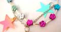 Fashion anklet design with heart and flower beads and chain hanging at the bottom with a bell, randomly pick