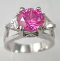 Rounded pink cz ring lie in the center with one clear cz on both sides made brass bass and plated with rhodium 
