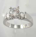 Fashion ring in brass base with clear rounded cz in middle with clear cz on both sides, rhodium plated 