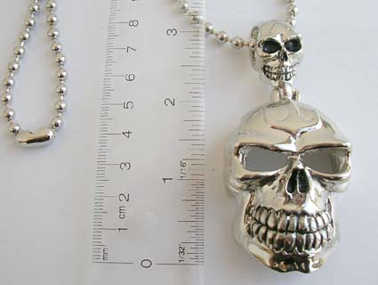 Fashion silver plated ball necklace holding two small and big skull ...