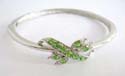 Fashion bangle with multi rounded green cz synthetic stone embedded in center design