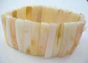 Fashion bracelet formed with long flat rectangular-shaped seashell in creamy color