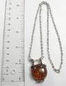 Fashion silver plated necklace with lobster clasp holding rounded imitation amber pendant at center