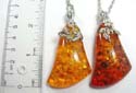 Fashion silver plated necklace with lobster clasp holding triangular shape imitation amber pendant at center. Assorted color randomly pick