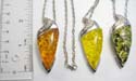 Fashion silver plated necklace with lobster clasp holding olive shape imitation amber pendant at center. Assorted color randomly pick