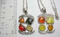 Silver plated fashion necklace pendant with assorted geometric design imitation amber beads embedded. Lobster clasp