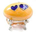 Enamel jewelry box motif an egg shape with blue double heart pattern in yellow color