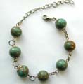 Fashion bracelet with multi green, pearl shape ceramic beads inlaid