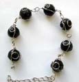 Fashion bracelet with multi wired-in black pearl shape plastic beads inlaid