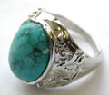 Fashion ring with an  oval shape genuine turquoise stone inlaid at center, pattern decor on each side