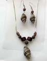 Fashion necklace and earring set with wooden beads chain holding a black spiral, olive shape seashell pendant