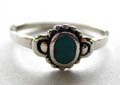 Sterling silver ring with dotted pattern around an oval shape blue turquoise stone at center