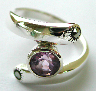 Central open design sterling silver ring with a rounded light purple cz stone embedded in middle and a mini marcasite stone on top and bottom end