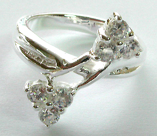Sterling silver ring with carved-out pattern holding 2 triangle pattern each with 3 mini rounded clear cz stone embedded