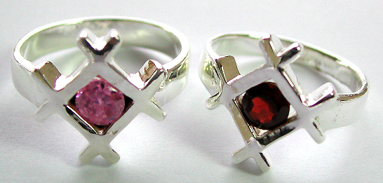Sterling silver ring with a rounded pinkish / red cz stone