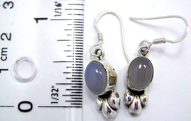 Sterling silver earring with moon stone inlay and floral pattern on bottom