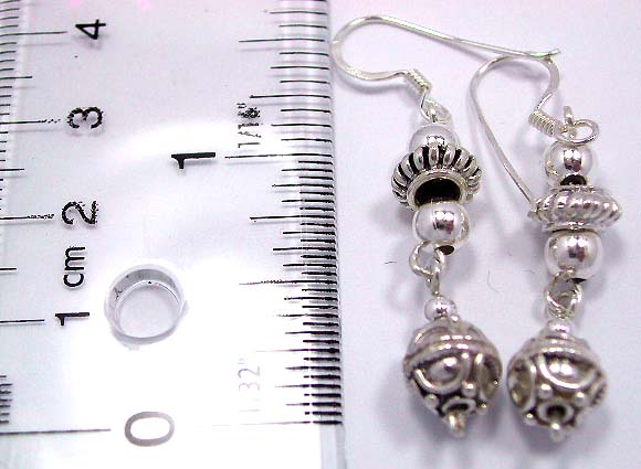 Fish hook back sterling silver earring with bali pearl and flower bead pattern holding a global bead on bottom   