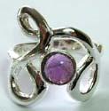 Sterling silver ring with carved-out twisted pattern holding an imitation rounded amethyst stone at center