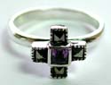 Sterling silver ring with 4 macasite stone forming cross pattern holding a square shape amethyst stone at center