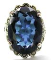 Sterling silver ring with multi mini marcasite stone embedded flower pattern holding a large dark blue cz stone in middle