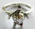 Sterlin silver ring with carved-out turtle pattern decor at center