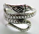 Sterling silver ring with carved-out snake pattern design at center