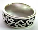 Wide band black shade sterling silver ring with carved-in heart knot pattern decor along