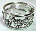 Wide band sterling silver ring with caved-out daisy flower pattern decor along 