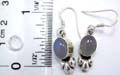Sterling siver earring with an oval shape moon stone embedded at center and floral pattern on bottom