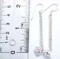 Sterling silver earring with spinning rope wrapped long strip holding a mini elephant pattern on bottom