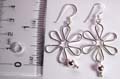 Sterling silver earring in carved-out flower pattern design with 1bigger and 2 mini spinning beads suspended on bottom