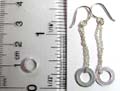 Sterling silver earring with chain loop holding a circle pattern on bottom