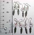 Sterling silver earring with beaded dream catcher pattern holding a silver leaf pattern on bottom