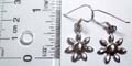 Sterling silver earring in carved-out sun flower pattern design, with fish hook back for convenience closure