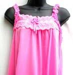One piece through pajama skirt in medium pinkish color; no sleeve; butterfly straps along arm cuffs; lace butterly knot front decor with 1/2" elastic back