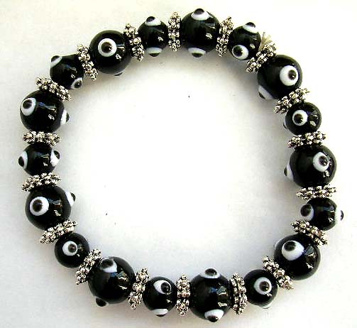 Multi black hand-painted lampwork glass beads ( mystical eye handmade beads ) and flat silver beads forming fashion stretchy bracelet

 
 
