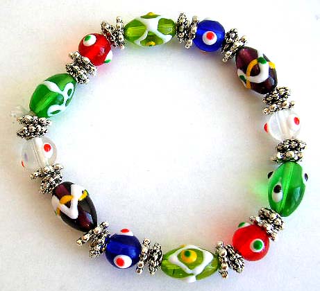 Fashion stretch bracelet with multi assorted color rounded and olive eye beads and flat silver beads inlaid              


 
 
