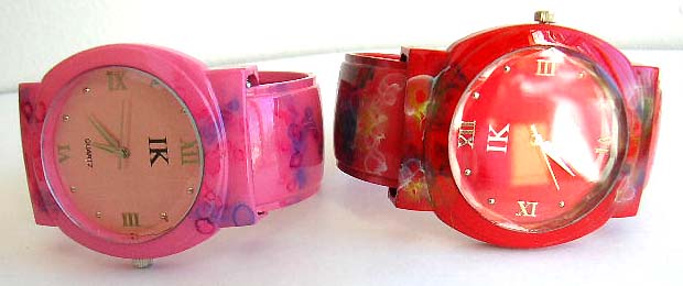 Fashion watch with rounded clock face design and floral decor on assorted color band