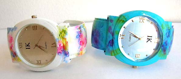 Fashion watch with rounded clock face design and floral decor on assorted color band