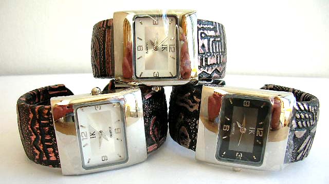 Black band fashion bangle watch with rectangular clock face design and carved-in flower decor on band