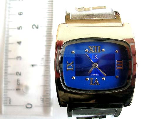 Fashion wide band bangle watch with rectangular clock face design and glof figure decor on band