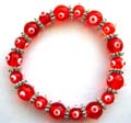Multi red hand-painted Chinese lampwork glass bead and flat silver beads forming fashion stretchy bracelet