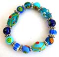 Fashion stretchy bracelet with multi long and rounded blue hand-painted Chinese lampwork glass bead and flat silver beads inlaid 