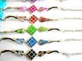 Fashion bracelet with 2 curve strips holding a gloden lines sectioning, enamel color diamond pattern decor at center, assorted color randomly pick