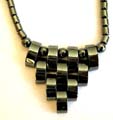 Multi short cylinder shape hematite beads forming fashion hematite necklace with multi curve beads forming triangle pendant decor at center 