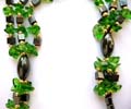 Fashion hematite necklace with multi short cylinder hematite beads inlaid and multi green quartz chips inlaid triple string pendant at center 