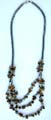 Fashion hematite necklace with multi short cylinder shape hematite beads inlaid and multi picture stone chips inlaid triple string pendant at center 